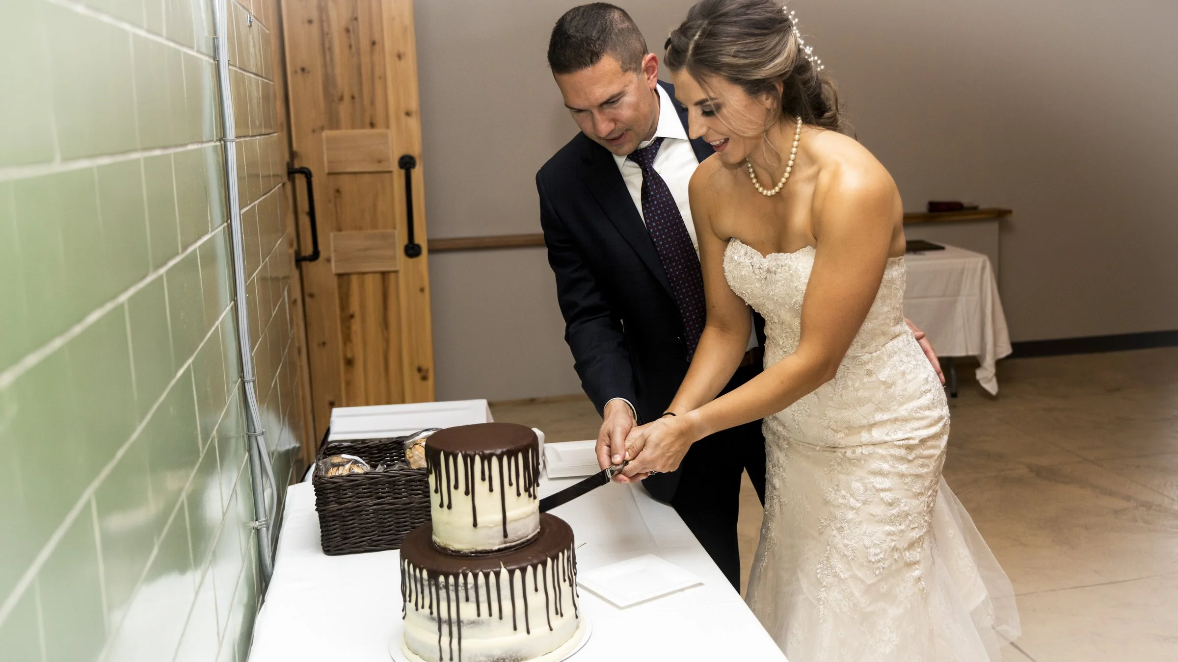 A couple cutting their wedding cake together