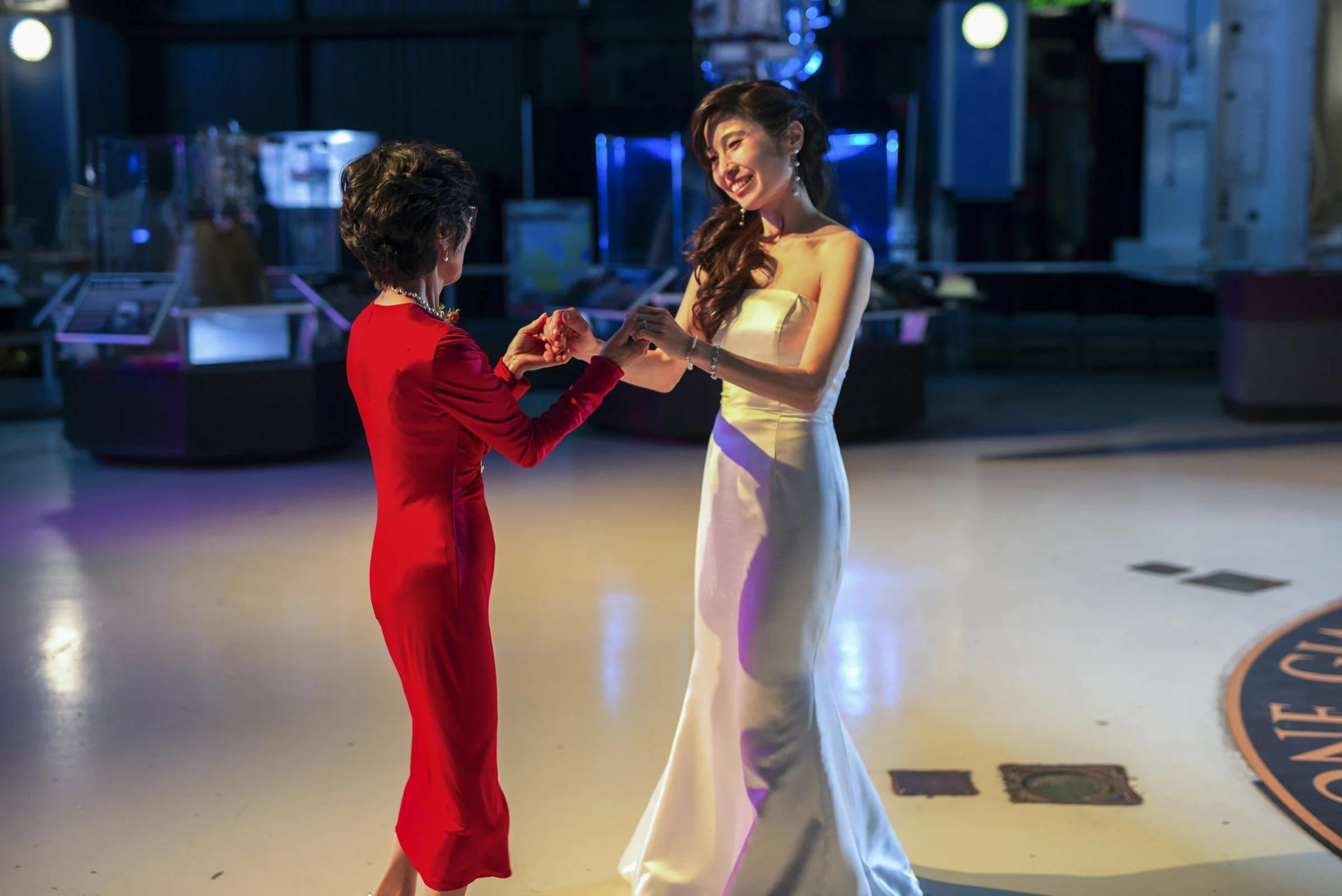 A bride and family member sharing a dance at a wedding reception